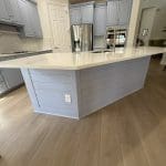 Bright white custom kitchen with an island by Premier Magnolia Homes