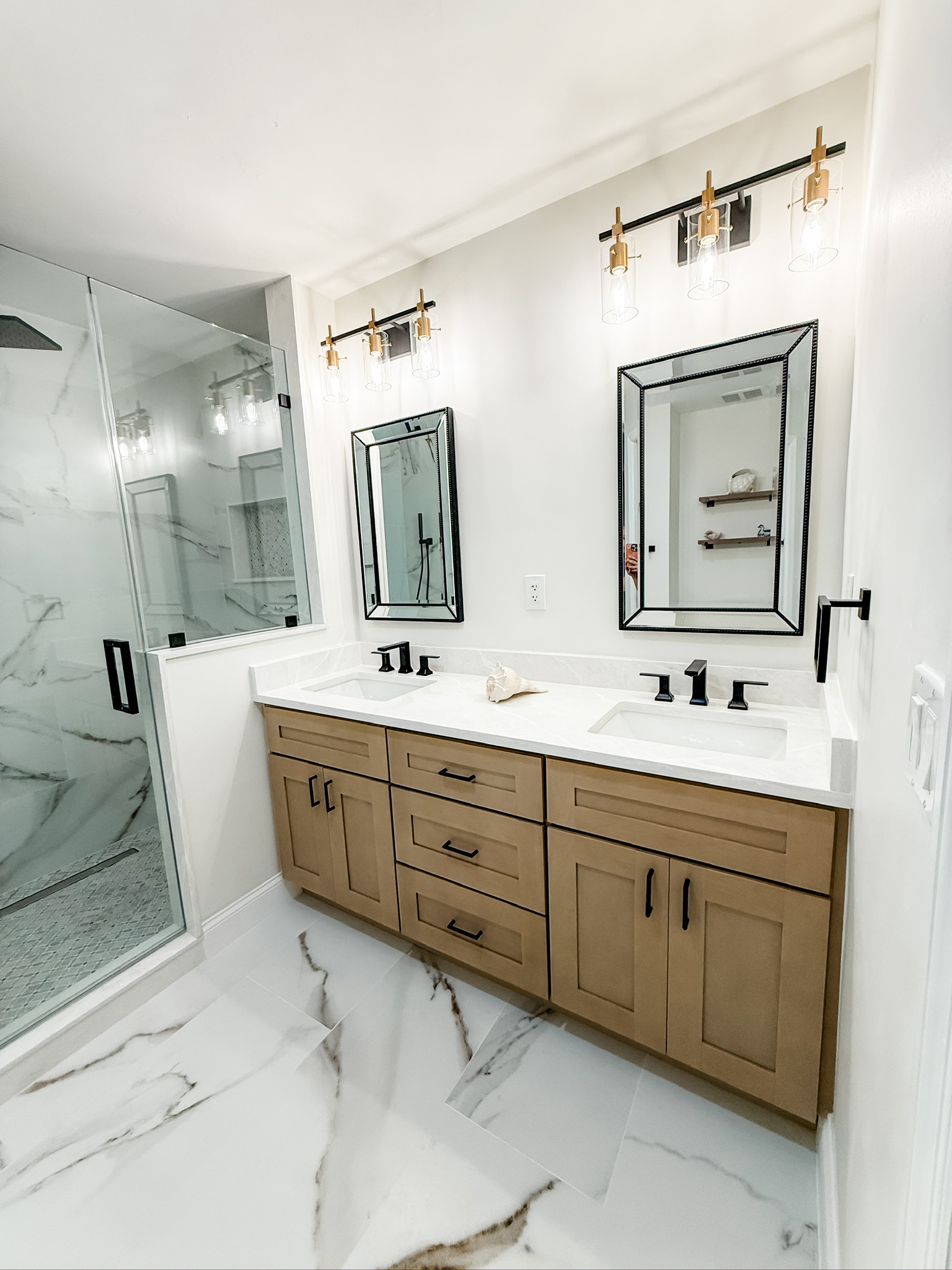 Primary bathroom with a wood double vanity by Premier Magnolia Homes