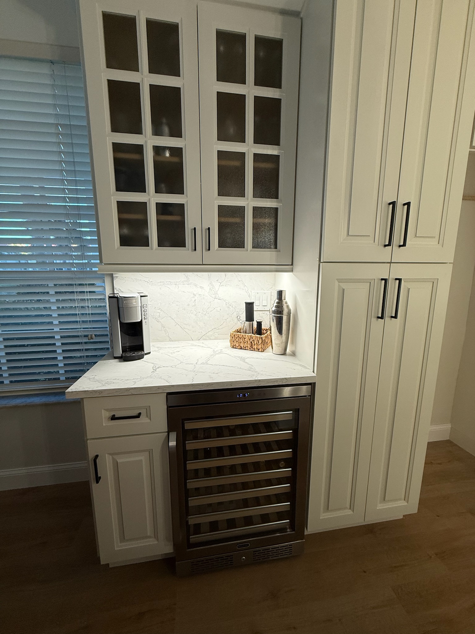 Butler pantry cabinetry with glass uppers and a built-in wine cooler