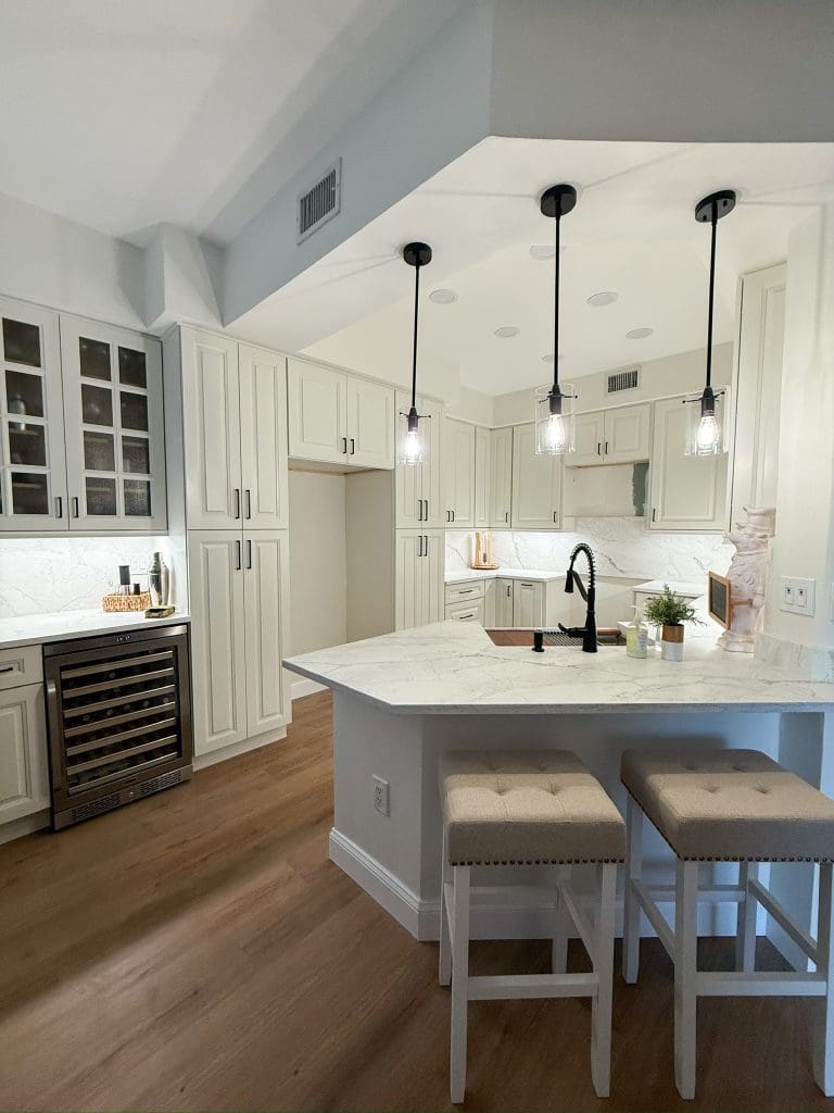 Open custom kitchen with a vaulted ceiling and island seating by Premier Magnolia Homes