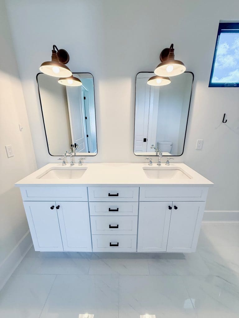 Custom bathroom with a double vanity by Premier Magnolia Homes