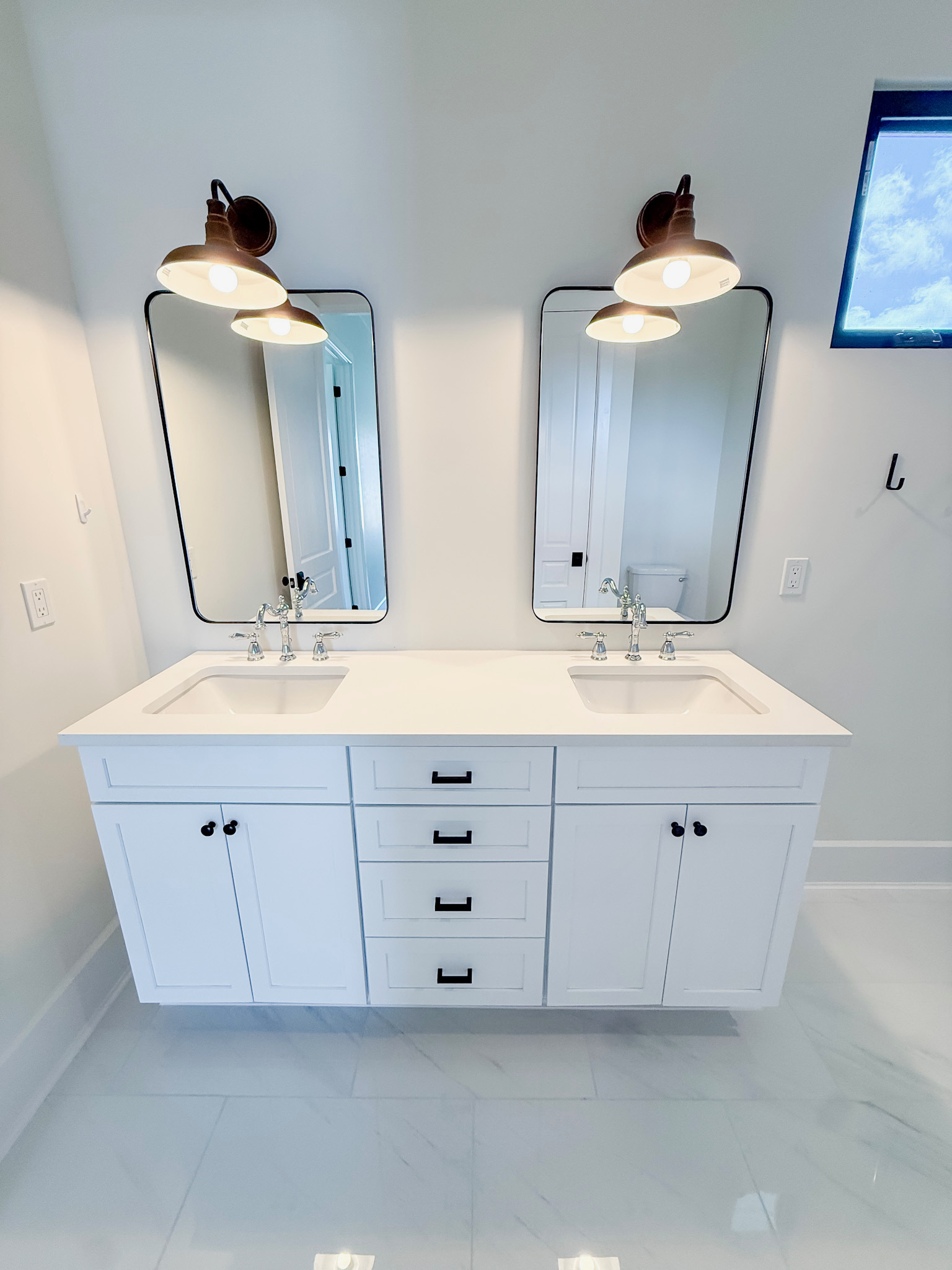 Custom bathroom with a double vanity by Premier Magnolia Homes