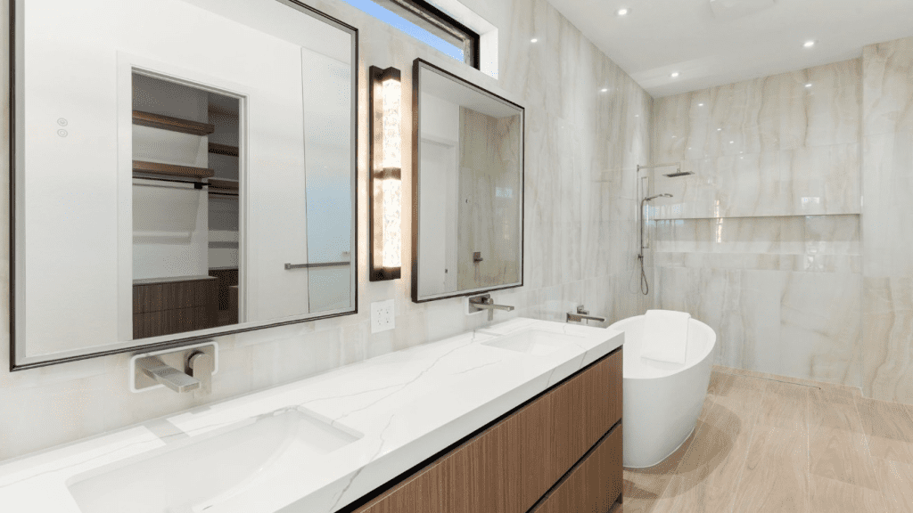 Primary bath with a freestanding tub and frameless glass shower