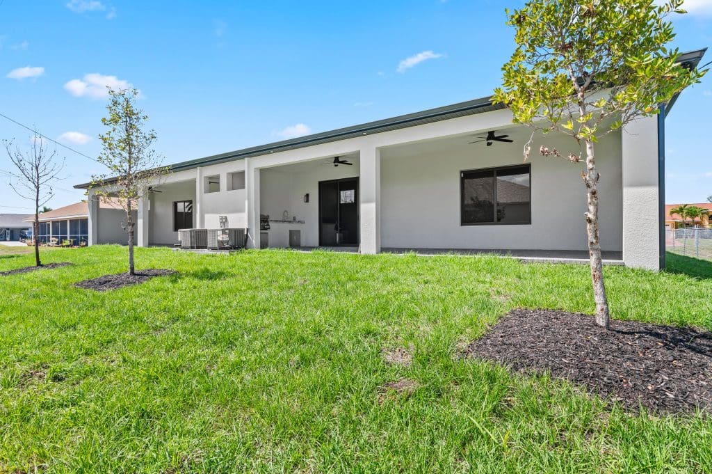 Custom home backyard with a covered lanai by Premier Magnolia Homes